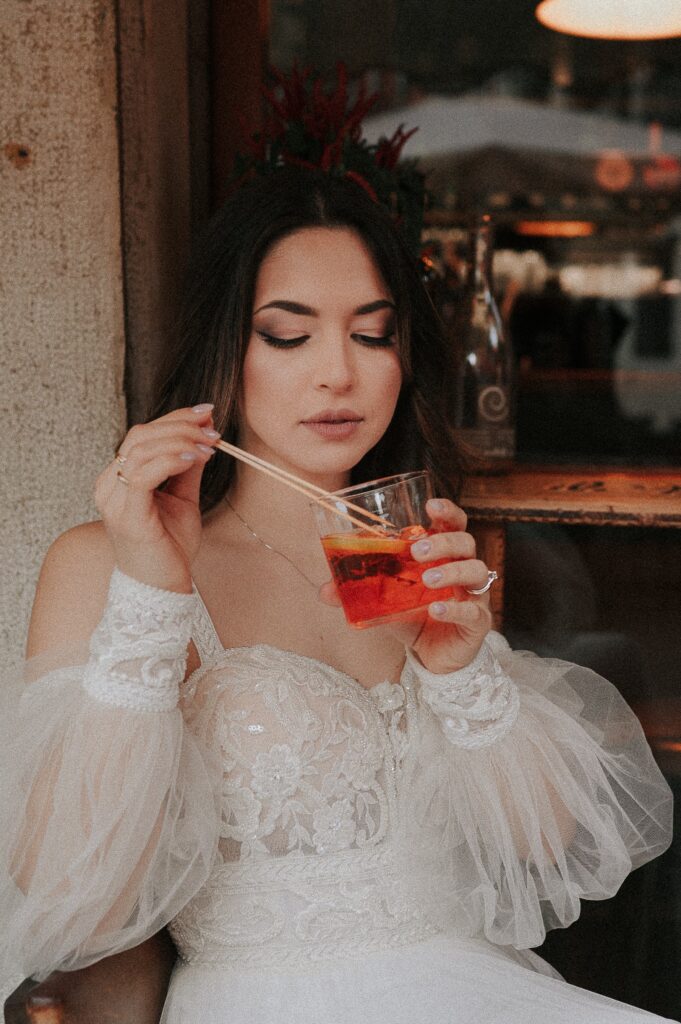 Enchanting Venetian canal scene captured by a Venice Wedding Photographer, highlighting the romantic ambiance of the city. Bride with Italian Spritz