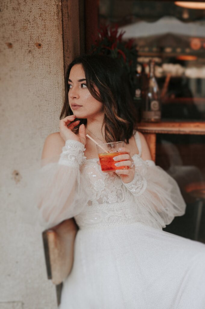 Enchanting Venetian canal scene captured by a Venice Wedding Photographer, highlighting the romantic ambiance of the city. Bride with Italian Spritz