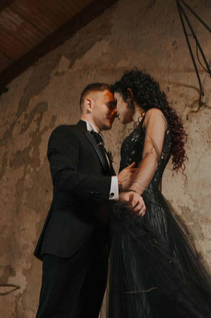 Elegant black Pronovias wedding dress displayed against the rustic and romantic backdrop of Borgo Fregnano, symbolizing unique bridal style and sophistication